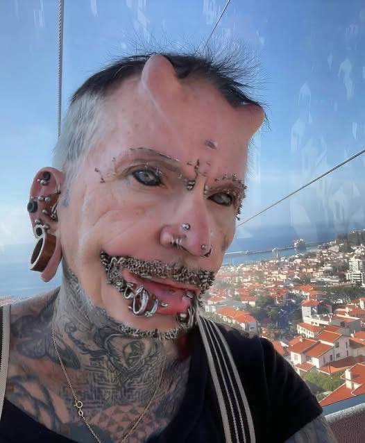 A man with 560 piercings, countless tattoos, and forehead implants
